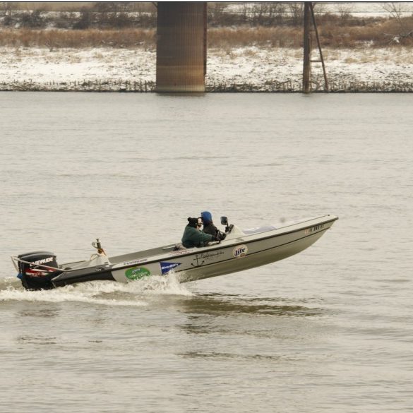 ski boat on the Mississippi River; nose of the boat high up in the air